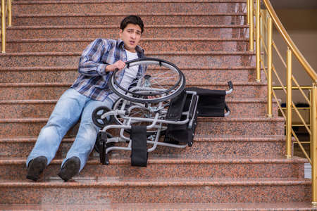 Disabled man on wheelchair having trouble with stairsの写真素材
