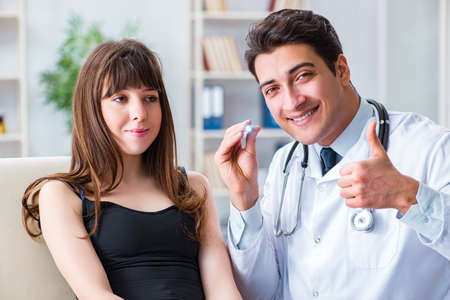 Doctor checking up patient in first aid conceptの写真素材