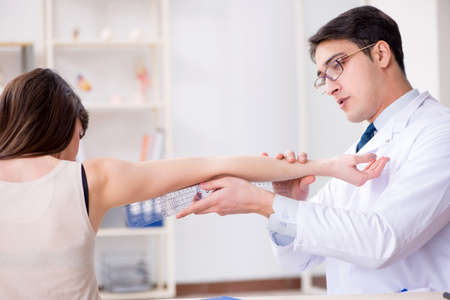 Doctor checking patients joint flexibility with gonimeterの写真素材