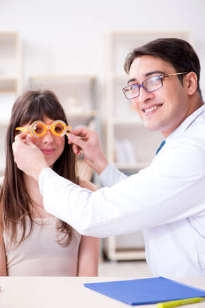 Ophthalmologist is checking up patient in eye doctor hospitalの写真素材