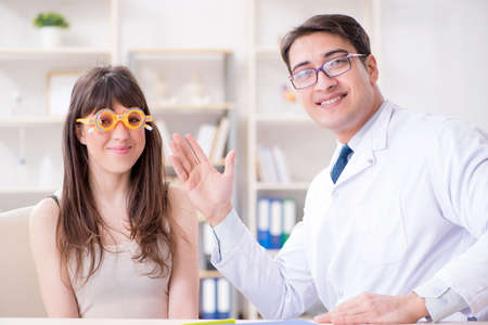 Ophthalmologist is checking up patient in eye doctor hospitalの写真素材