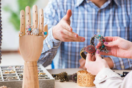 Woman visiting jeweler for jewelery evaluation