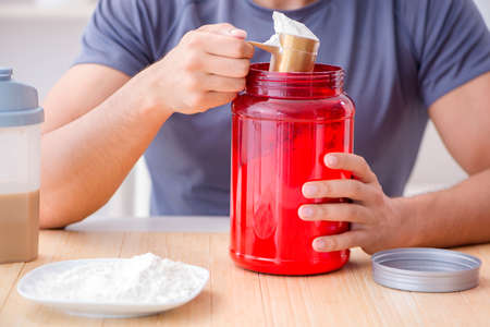 Athlete tasting new protein supplements for better muscles