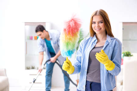 Young family cleaning the house