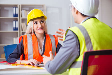 Construction workers having discussion in office before starting
