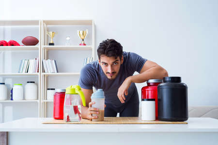 Athlete tasting new protein supplements for better musclesの写真素材