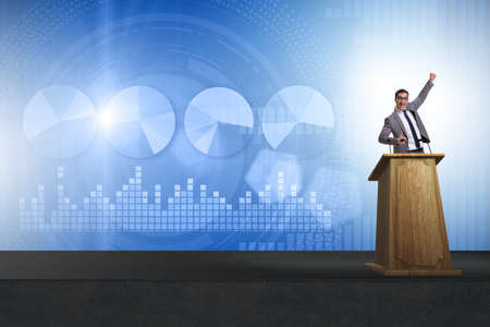 Man businessman making speech at rostrum in business conceptの写真素材