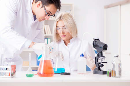 Two chemists having discussion in labの写真素材