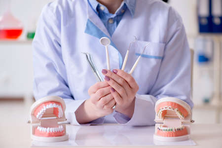 Dentist practicing work on tooth modelの写真素材