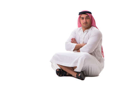 Young arab man sitting isolated on whiteの写真素材