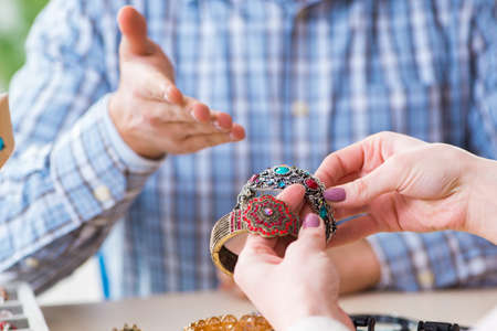 Woman visiting jeweler for jewelery evaluation