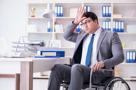 Disabled businessman working in the officeの写真素材