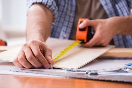 Young man in woodworking hobby conceptの写真素材