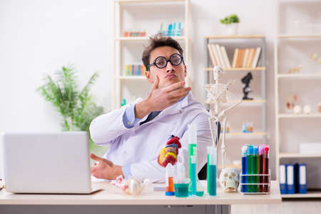 Funny doctor having fun in hospital labの写真素材