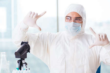 Young chemist pressing virtual buttons in lab