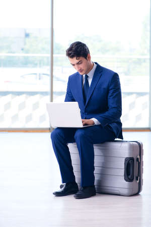 Businessman waiting for his flight at airportの写真素材