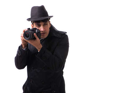 Spy with camera taking pictures isolated on white backgroundの写真素材