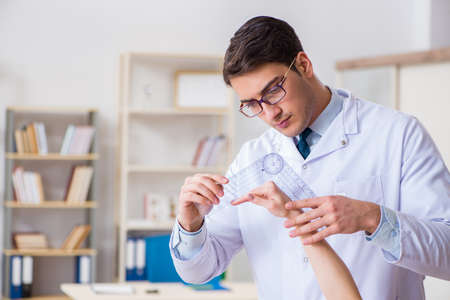 Doctor checking patients joint flexibilityの写真素材