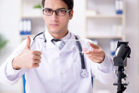 Safety doctor advising about wearing protective gogglesの写真素材