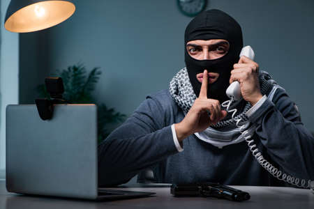 Terrorist wearing balaclava talking on phone