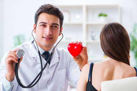 Doctor checking patient with stethoscopeの写真素材