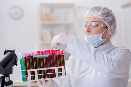 Woman doctor checking blood samples in lab