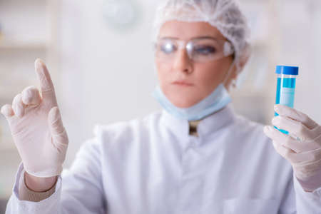 Woman chemist pressing virtual button in labの写真素材