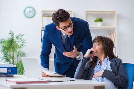 Pregnant woman struggling in the office and getting colleague heの写真素材