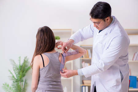 Doctor checking patients joint flexibilityの写真素材