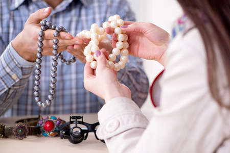 Woman visiting jeweler for jewelery evaluationの写真素材