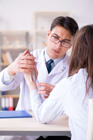 Doctor checking patients joint flexibility with gonimeterの写真素材