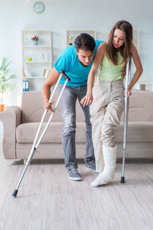 Husband man supporting injured wifeの写真素材