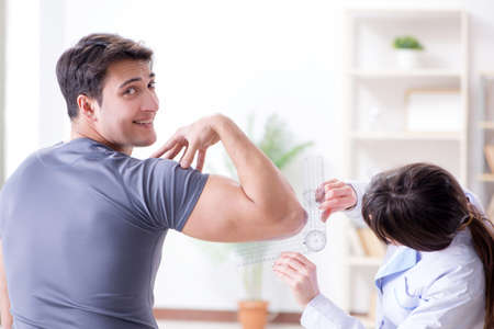 Doctor checking patients joint flexibility with gonimeterの写真素材