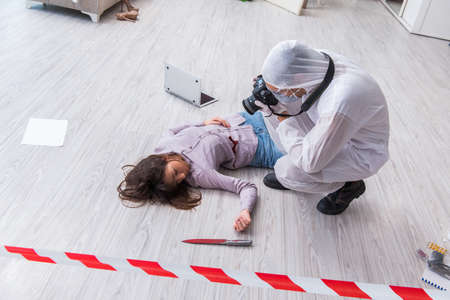 Forensic investigator at the crime scene investigating woman murの写真素材