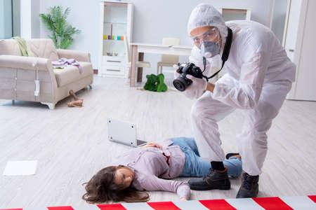 Forensic investigator at the crime scene investigating woman mur