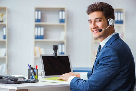 Young help desk operator working in office