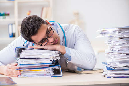 Busy doctor with too much work in hospitalの写真素材