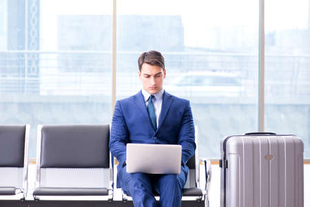 Businessman waiting at the airport for his plane in business claの写真素材