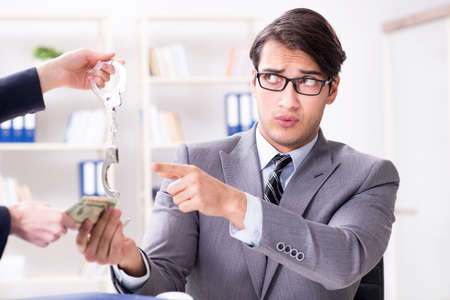 Businessmanbeing offered bribe for breaking lawの写真素材