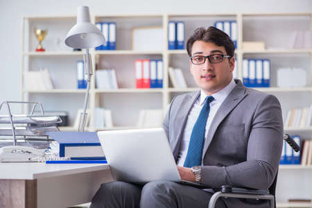 Disabled businessman working in the officeの写真素材
