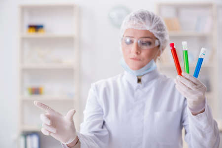 Woman chemist pressing virtual button in labの写真素材