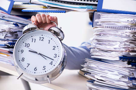 Extremely busy businessman working in office