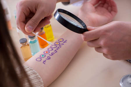 Doctor testing allergy reaction of patient in hospitalの写真素材