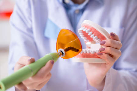 Dentist practicing work on tooth model