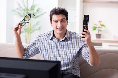 Man watching 3d tv at home