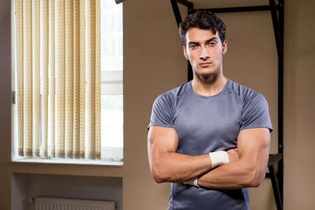 Ripped muscular man in gym doing sportsの写真素材