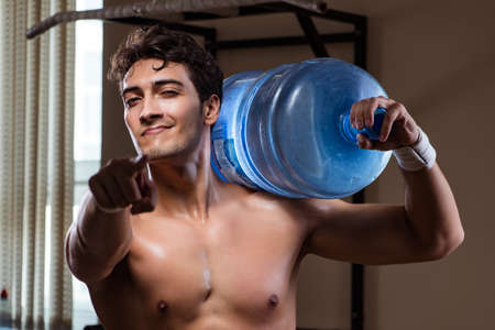 Muscular ripped man with big water bottleの写真素材