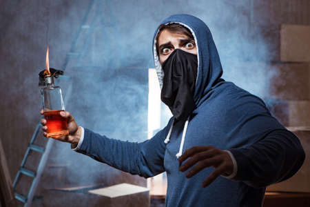 Rebel with molotov cocktail in dark room
