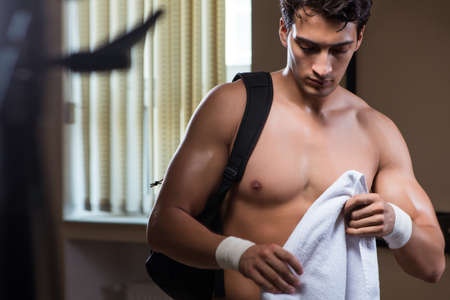 Man tired after workout in sports gymの写真素材