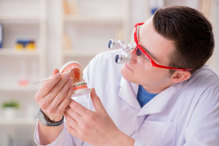 Dentist working teeth implant in medical lab